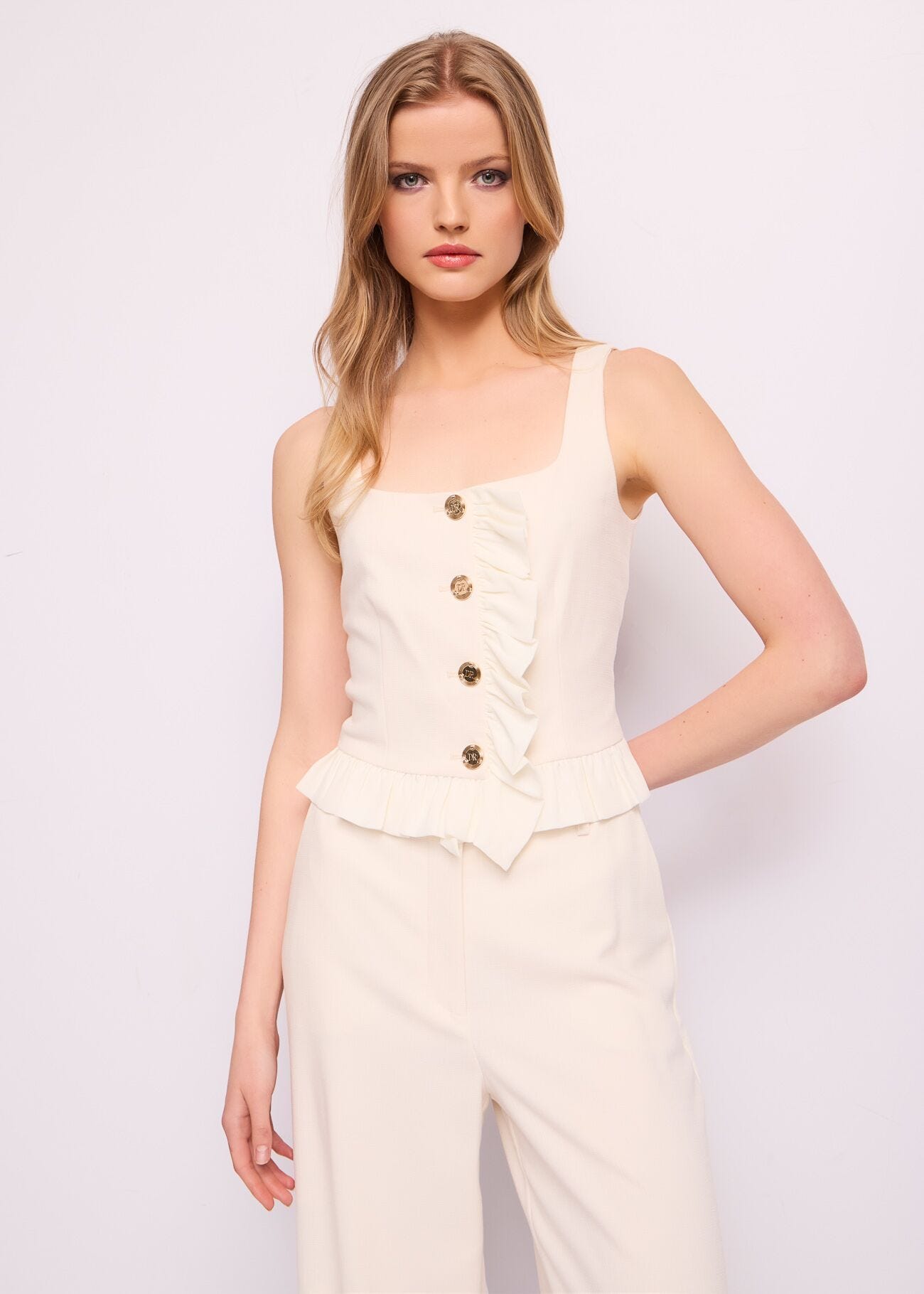 White vest with logo buttons